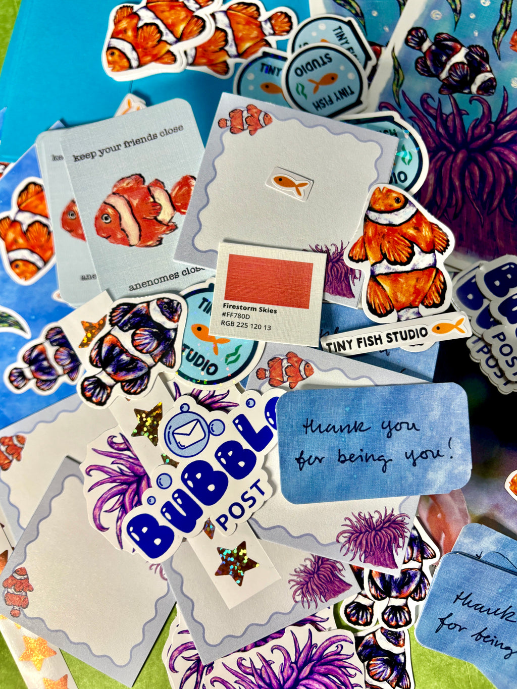 Collection of colorful stickers with fish and ocean-themed designs on a blue background.
